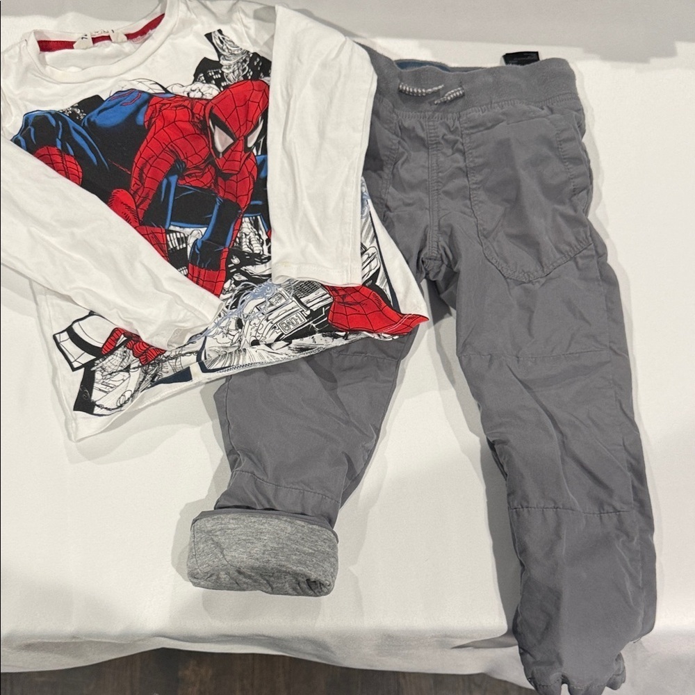 H&M Red and Blue Spider Graphic Tee and gray pants.